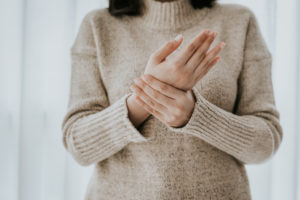 woman in sweater with carpal tunnel