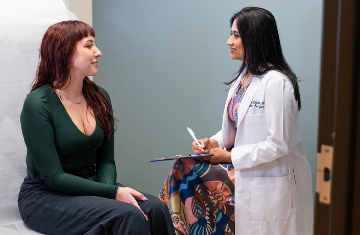 Dr. Hetal Fichadia sitting down speaking with a patient